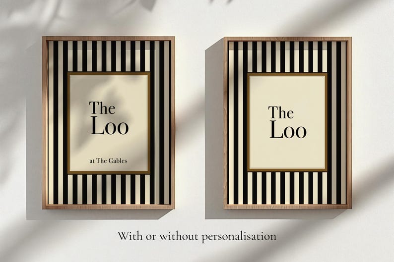 May include: Two framed art prints with the text "The Loo" in a serif font. The frames have a black and white striped pattern with a light wood border. The text "at The Gables" is below the main text.