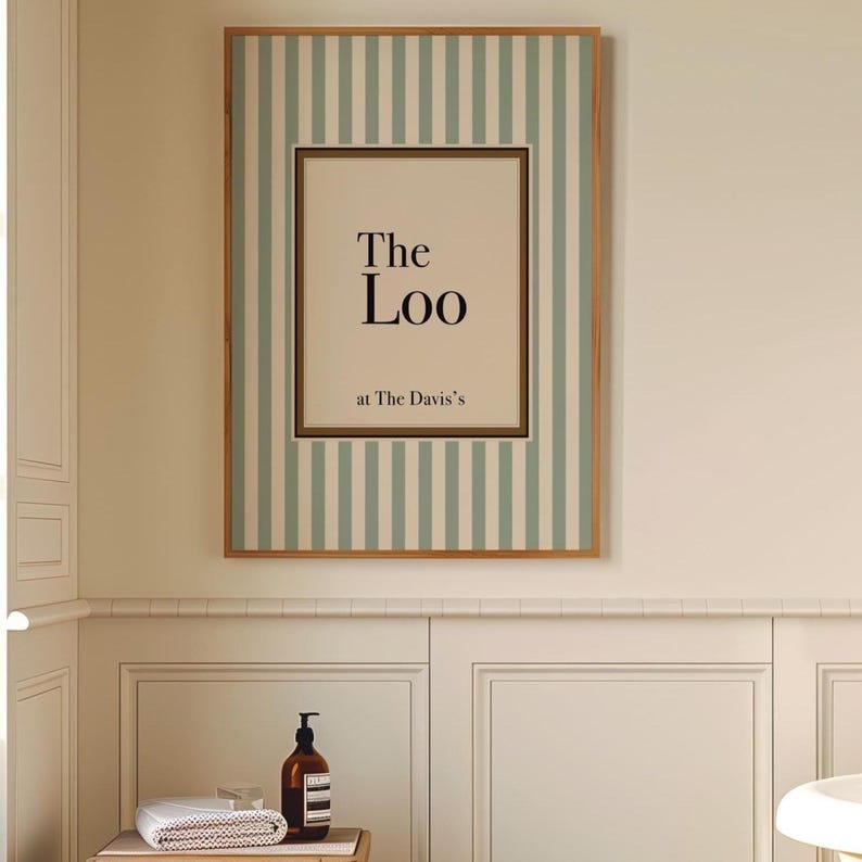 Framed personalised “The Loo” bathroom sign with sage green stripes hanging above a bathroom vanity