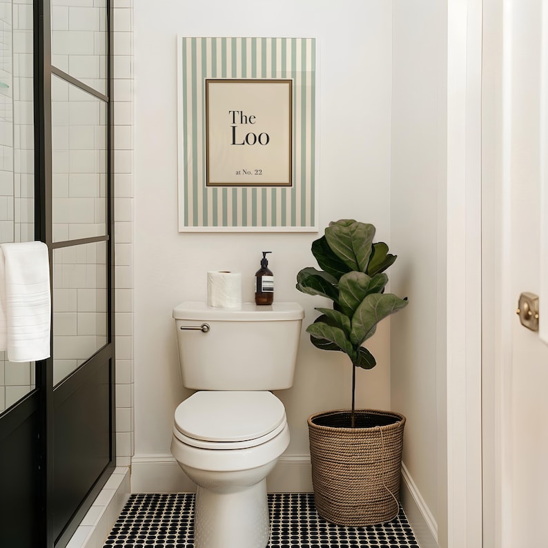 Personalised “The Loo” bathroom sign with sage green stripes displayed above a toilet in a modern powder room