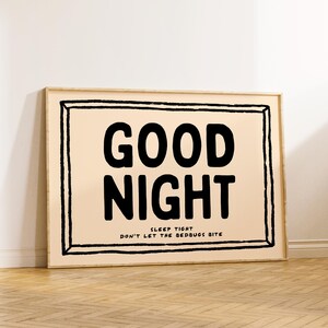 May include: A framed print with a peach background and black text that reads "GOOD NIGHT SLEEP TIGHT DON'T LET THE BEDBUGS BITE".