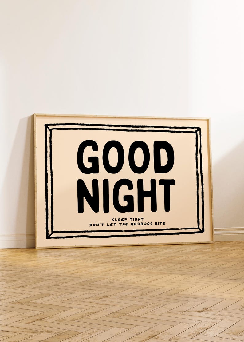 May include: A framed print with a peach background and black text that reads "GOOD NIGHT SLEEP TIGHT DON'T LET THE BEDBUGS BITE".