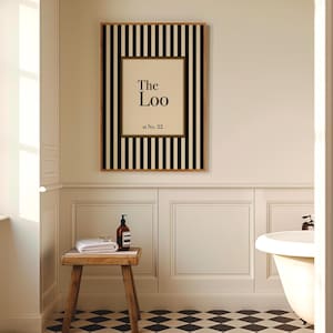 Classic black and cream striped “The Loo” bathroom print with optional personalisation, displayed in a traditional panelled bathroom interior with checkerboard flooring.