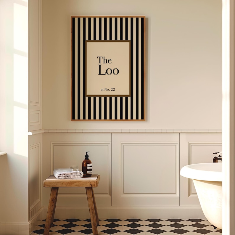 Classic black and cream striped “The Loo” bathroom print with optional personalisation, displayed in a traditional panelled bathroom interior with checkerboard flooring.