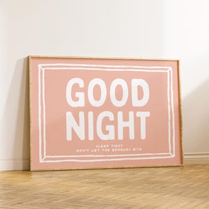 May include: A framed print with a pink background and white text that reads "GOOD NIGHT SLEEP TIGHT DON'T LET THE BEDBUGS BITE".