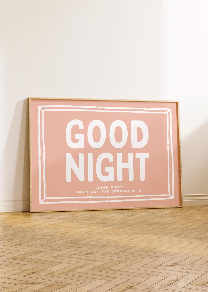 May include: A framed print with a pink background and white text that reads "GOOD NIGHT SLEEP TIGHT DON'T LET THE BEDBUGS BITE".