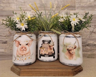 Variety of decorative handcrafted glass jars with farm animals. Farmhouse home decor