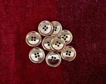 Card of 9 vintage buttons from 1960s. Coated gold tone circular edged design. Medium size plastic buttons. Crafts, jewellery making.