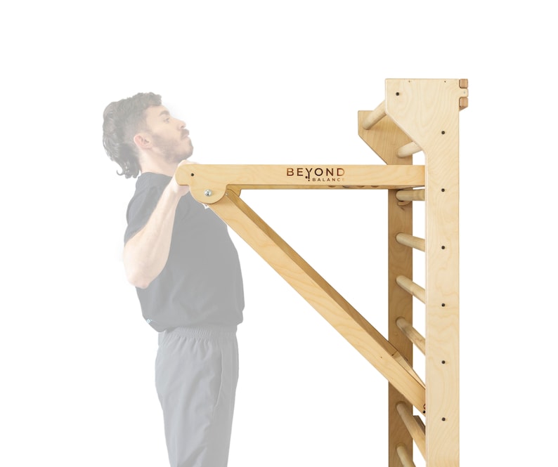 May include: A wooden pull-up bar attached to a wooden wall ladder. The pull-up bar is labeled "BEYOND BALANCE".