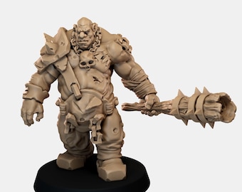 May include: A tan-colored miniature figurine of a muscular humanoid creature with a skull emblem on its chest, wearing shoulder armor and chains, holding a large, spiked wooden club in its left hand, standing on a circular black base.
