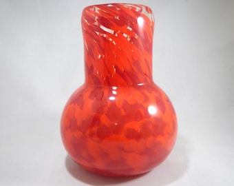 Hand blown glass vase in shades of red