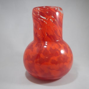 Hand blown glass vase in shades of red