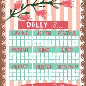 May include: A decorative poster with a pink and white striped background and a brown border. The poster features the words "DOLLY IS..." and lists positive attributes such as "LOVING", "JOYFUL", and "PEACEFUL". A banner at the bottom reads "We love you, Dolly!"