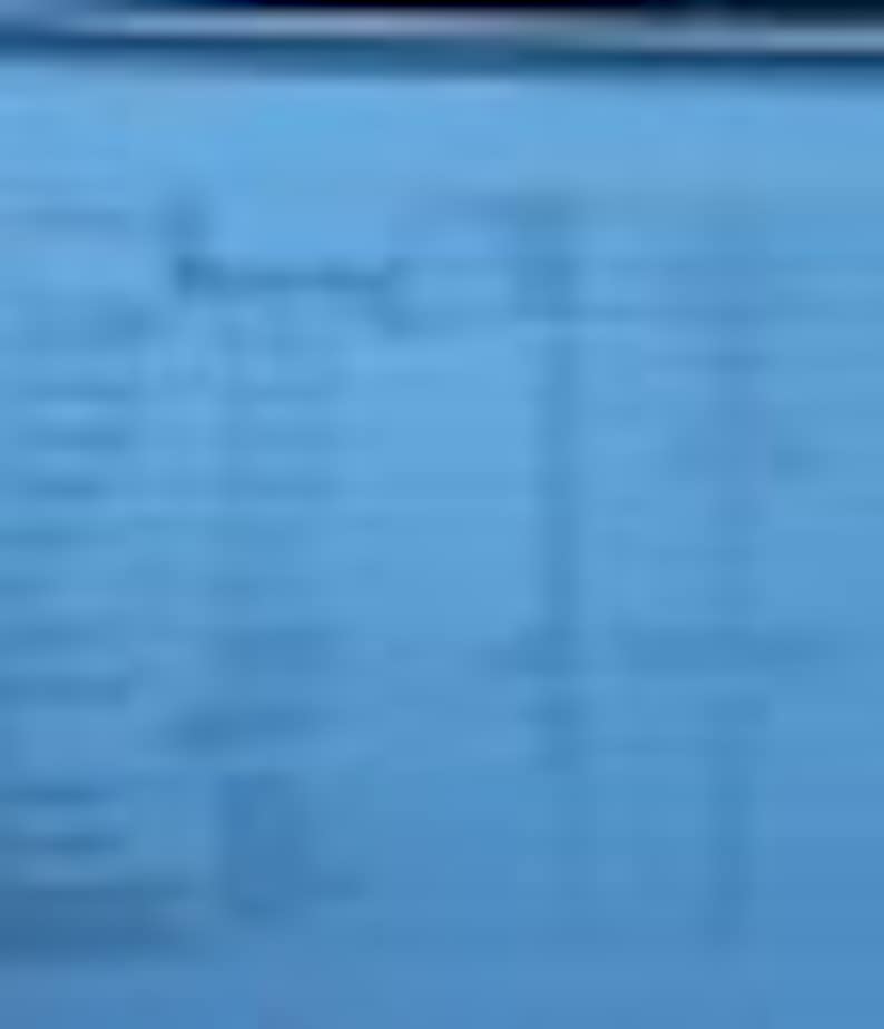 May include: A blue sheet of paper with a table of data. The table has multiple columns and rows with text. The text is small and difficult to read. The paper is slightly wrinkled.
