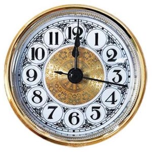 May include: A round clock insert with a gold-colored metal bezel. The white face features black Arabic numerals from 1 to 12 inside circular borders. The center has a gold-toned decorative pattern with black hour, minute, and second hands.