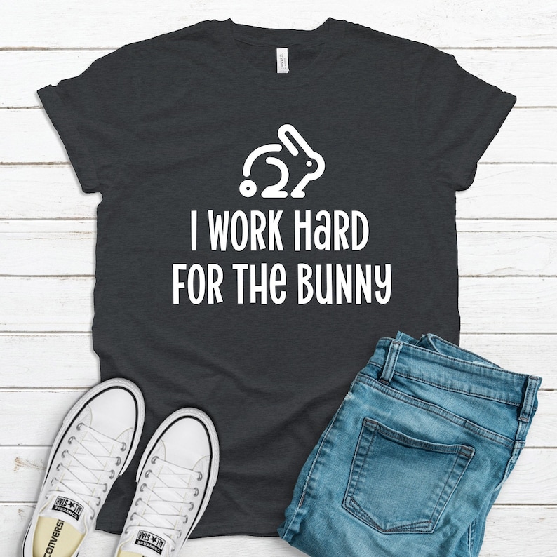 Dark gray graphic t-shirt with rabbit design that says I Work Hard For The Bunny.