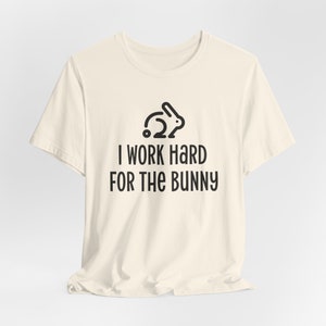 Natural color graphic t-shirt with rabbit design that says I Work Hard For The Bunny.