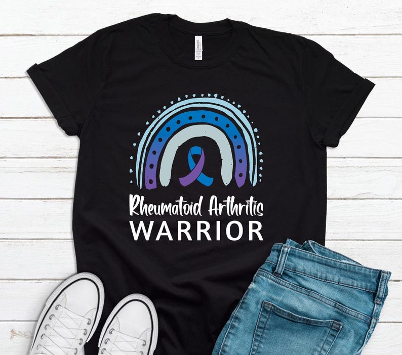 Black graphic t-shirt with blue and purple rainbow and ribbon that says Rheumatoid Arthritis Warrior