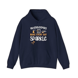 Navy blue hoodie with cleaning icons that says Housekeepers Make Every Day Sparkle