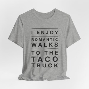 Light gray graphic t-shirt that says I Enjoy Romantic Walks to the Taco Truck.