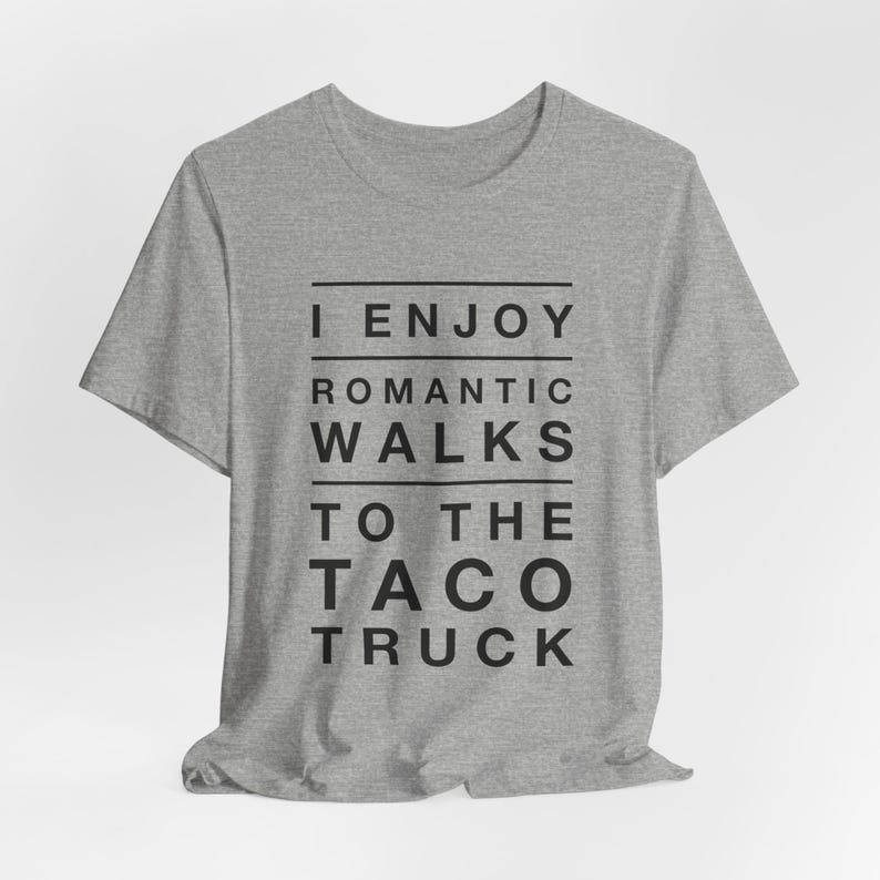 Light gray graphic t-shirt that says I Enjoy Romantic Walks to the Taco Truck.