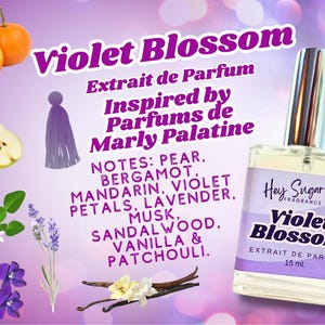 May include: A clear glass bottle of Violet Blossom perfume, inspired by Parfums de Marly Palatine. The bottle is labeled with the brand name "Hey Sugar Fragrance Co." and the perfume name "Violet Blossom." The bottle is 15 ml. The image also includes a variety of fruits, flowers, and other botanicals, including pears, mandarin oranges, lavender, and vanilla beans.