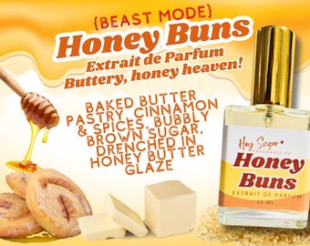 May include: A 15 ml bottle of Honey Buns Extrait de Parfum by Hey Sugar Fragrance Co. The bottle is clear glass with a gold cap and label. The label features a pink heart and the text "Honey Buns" in a white font. The background features a yellow and orange gradient with images of honey, cinnamon rolls, and butter.