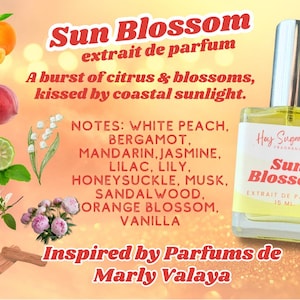 May include: A glass bottle of Sun Blossom perfume, inspired by Parfums de Marly Valaya. The bottle is filled with a light yellow liquid and has a white label with the brand name and product name. The label also lists the notes of the fragrance, including white peach, bergamot, mandarin, jasmine, lilac, lily, honeysuckle, musk, sandalwood, orange blossom, and vanilla.