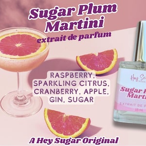 May include: A perfume bottle and a cocktail glass with a grapefruit slice, alongside grapefruit wedges. The bottle is labeled "Sugar Plum Martini" with "extrait de parfum". The ingredients listed are raspberry, citrus, cranberry, apple, gin, and sugar.