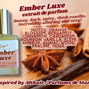 May include: A perfume bottle labeled "Ember Luxe" with a silver cap, set against a backdrop of cinnamon sticks, star anise, and vanilla bean. The label lists fragrance notes and the text "Inspired by Althair / Parfums de Marly."