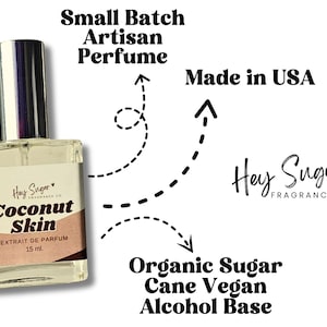 May include: A clear glass perfume bottle with a silver cap and a label that reads "Coconut Skin." The label also states "Extrait de Parfum" and "15 ml." Additional text includes "Small Batch Artisan Perfume," "Made in USA," and "Organic Sugar Cane Vegan Alcohol Base."