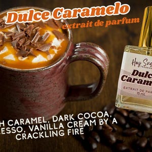 May include: A coffee mug with caramel-flavored coffee, whipped cream, and chocolate shavings, beside a 15 ml perfume bottle labelled "Dulce Caramelo". The text reads "Rich Caramel, Dark Cocoa, Espresso, Vanilla Cream by a Crackling Fire."