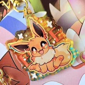 Juego de llavero y pegatinas de Eevee Pokémon: dije acrílico de doble cara