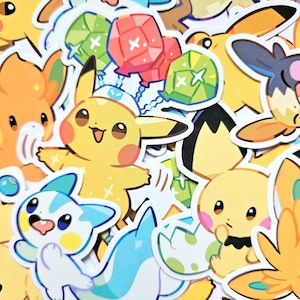 May include: A collection of colourful cartoon character stickers featuring a yellow Pikachu holding balloons, a blue and white cat, and a variety of other characters.