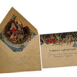 May include: A vintage Christmas greeting card and matching envelope. The card features a horse-drawn carriage in a snowy landscape with the text A MERRY CHRISTMAS and Sincere wishes for a most happy Christmas Season. The envelope has a decorative liner.