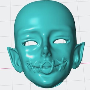May include: A turquoise blue doll head with pointed ears and a stitched mouth. The doll's eyes are closed.