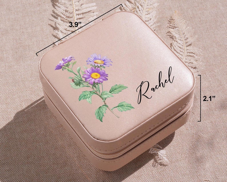 a pink suitcase with a purple flower painted on it