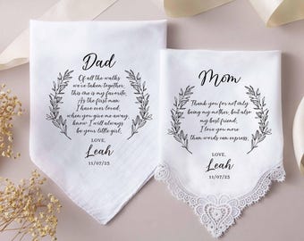 May include: Two white fabric handkerchiefs with black printed text and leaf wreath designs. One is labelled Dad with a poem from Leah dated 11/07/23. The other is labelled Mom with a message from Leah dated 11/07/23, featuring a white lace trim edge.