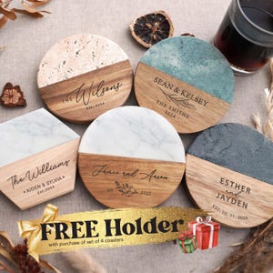May include: A collection of personalized coasters with names and dates. The coasters feature wood, marble, and stone elements. The text "FREE Holder" is displayed on a gold ribbon.