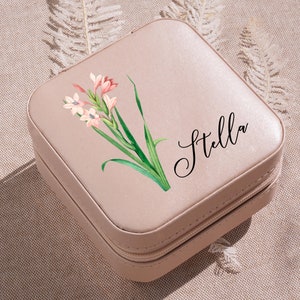 a pink suitcase with a flower painted on it