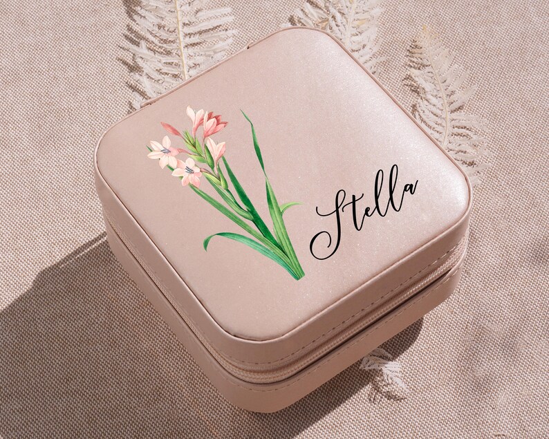 a pink suitcase with a flower painted on it