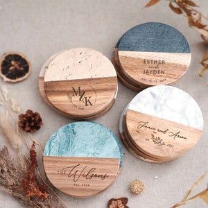 three personalized wooden coasters sitting on a table