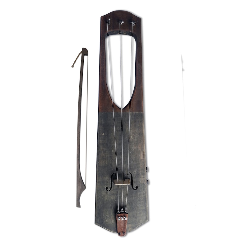 May include: A wooden lyre with four strings and a brown wooden bow. The lyre is a musical instrument that is played by plucking the strings.
