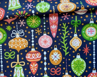 May include: A navy blue fabric with a repeating pattern of colorful Christmas ornaments. The ornaments are in shades of orange, green, pink, and white, with star and bell accents. The design includes small gold dots.
