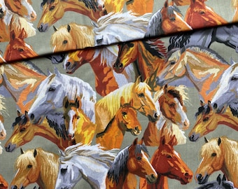 May include: Fabric with a repeating pattern of horse heads in various colors, including white, brown, orange, and gray. The horses are set against a muted green background, creating a textured, artistic design.