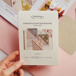 May include: A set of four personalized bookmark mini kits. Each kit features a different season: Spring, Summer, Fall, and Winter. The kits are made of fabric and feature embroidered details. The text on the card reads "Personalized Bookmark - Mini Kit - Design: Spring/Summer/Fall//Winter".