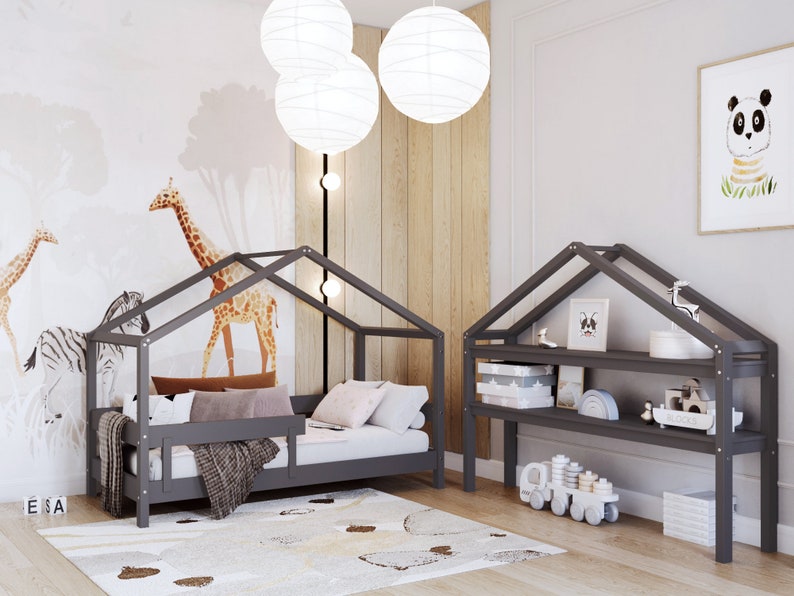 May include: A gray wooden house-shaped bed frame with a gray mattress and a gray blanket. The bed is decorated with pillows and a throw blanket. There is a gray wooden shelf unit with two shelves and a panda bear print on the wall.