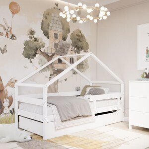May include: White wooden bed frame with a house-shaped canopy, featuring a grey and white bedding set. The bed has a pull-out drawer for storage. The room features a white dresser and a whimsical wall mural with a treehouse and animals.