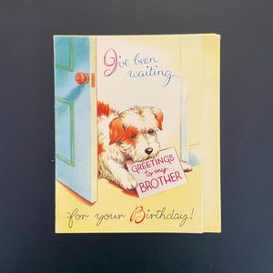 May include: A vintage birthday card featuring a dog holding a sign that reads "Greetings to my Brother." The card has a blue door and the text "I've been waiting" and "for your Birthday!" in script.