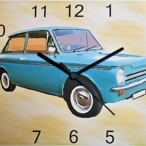 May include: A blue vintage car clock with black hands and white numbers. The clock face is surrounded by a light yellow background.