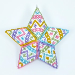 May include: A colorful star-shaped ornament made of beads. The star is made of pink, blue, green, white, and yellow beads. The beads are arranged in a geometric pattern.